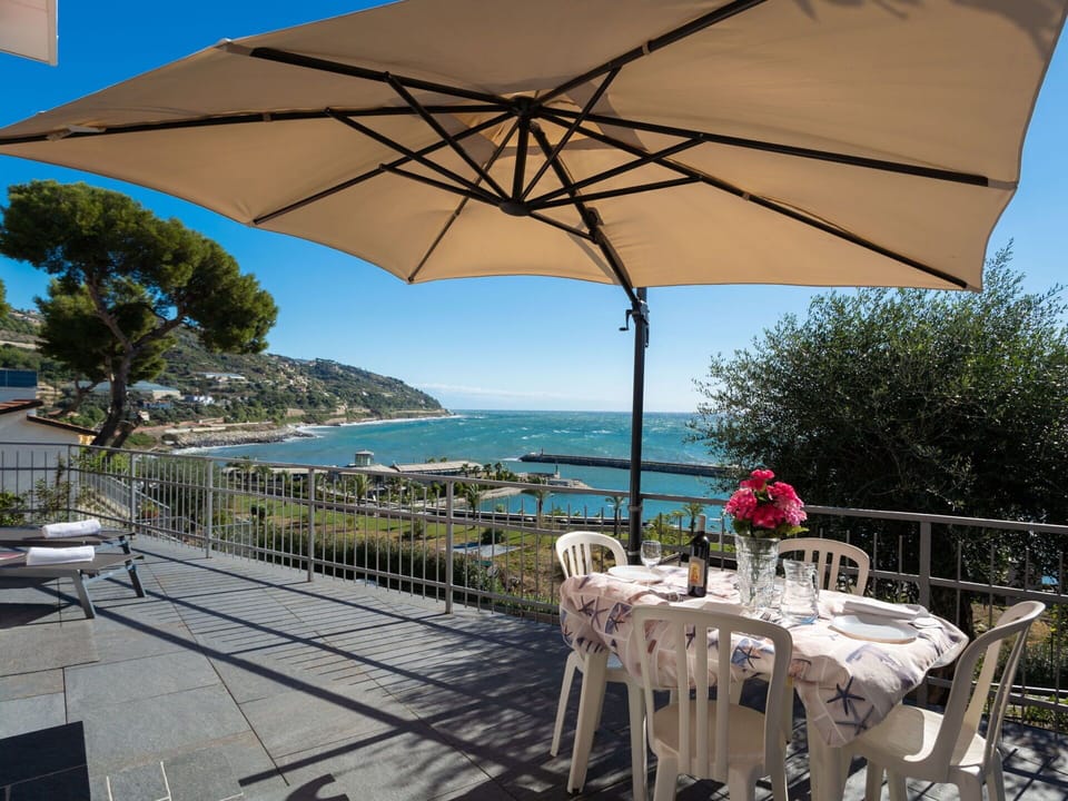 Umbrella, Property, Shade, Fashion Accessory, Vacation, Patio, Table, Furniture, Real Estate, Restaurant