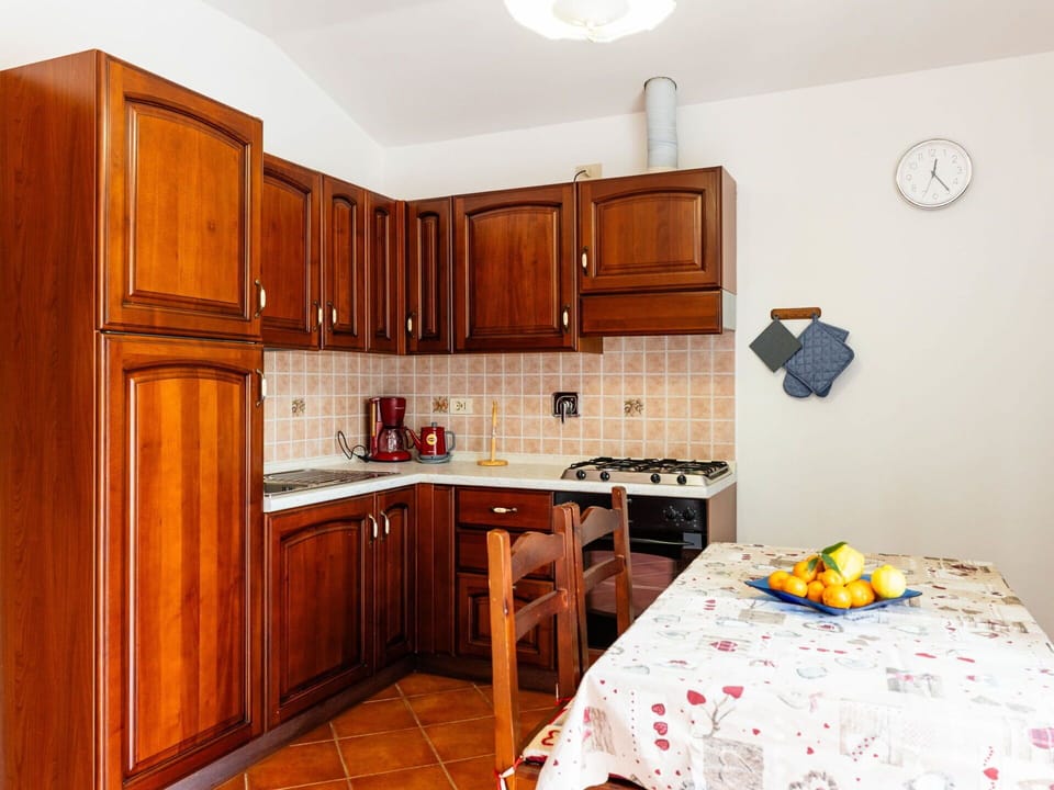 Wood, Interior Design, Kitchen, Cabinetry, Flooring, Kitchen Appliance, Room, Furniture, Countertop, Major Appliance