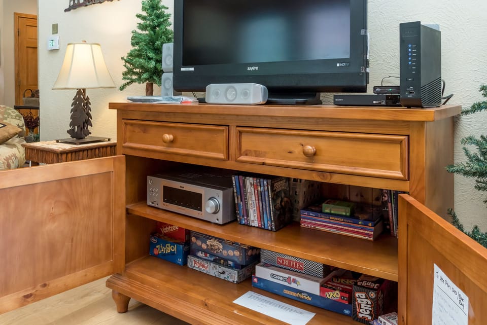 The den cabinet includes a DVD/Blueray player, games, movies and kids books.
