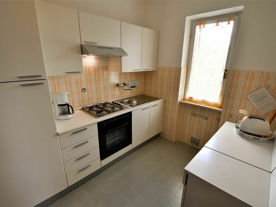 Cabinetry, Countertop, Property, Furniture, Kitchen Stove, Window, Kitchen Appliance, Sink, Wood, Drawer