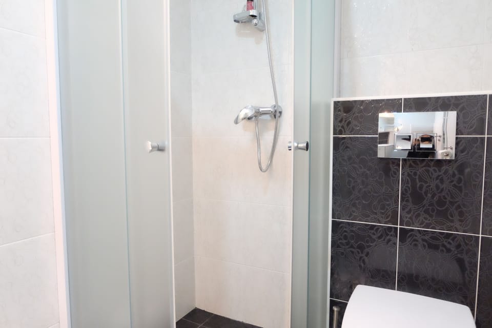 Shower, rainfall showerhead, hair dryer, towels