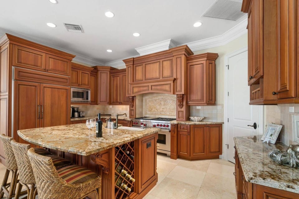 The oversized gas Wolf range, Sub-Zero refrigerator and walk-in pantry make this kitchen a chef's dream.