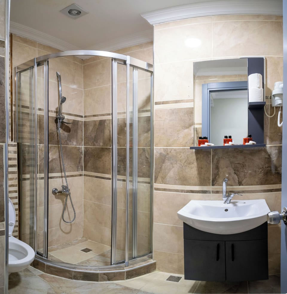 Shower, hair dryer, slippers, towels