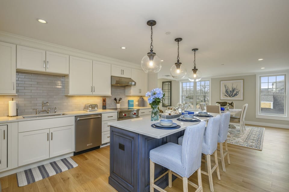 Open Concept Luxury Kitchen and dining room with large center island with seating for 3.