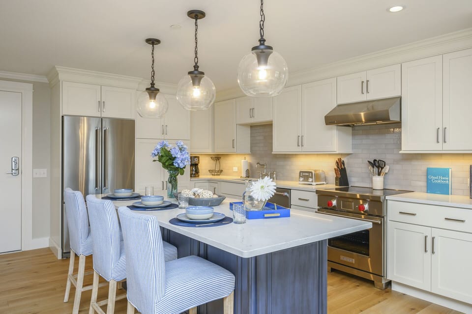 Luxury style Kitchen with stainless appliances , chefs  oven and large center island with seating for 3.