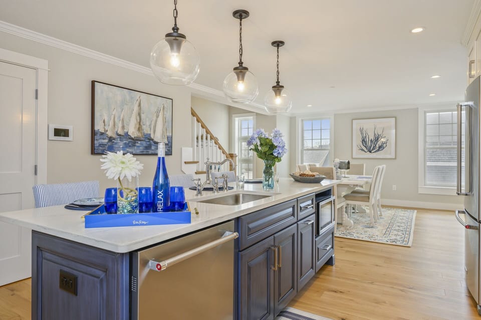 Luxury open concept kitchen and dining room with dishwasher and microwave in large island