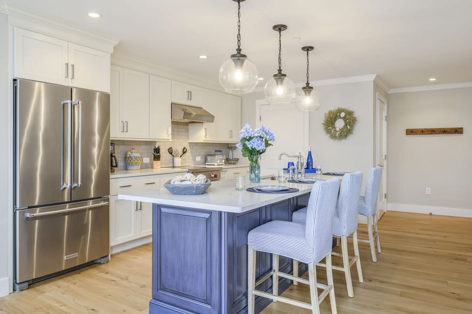 Beautiful Chefs kitchen with seating for 3 at the center island with all stainless appliances