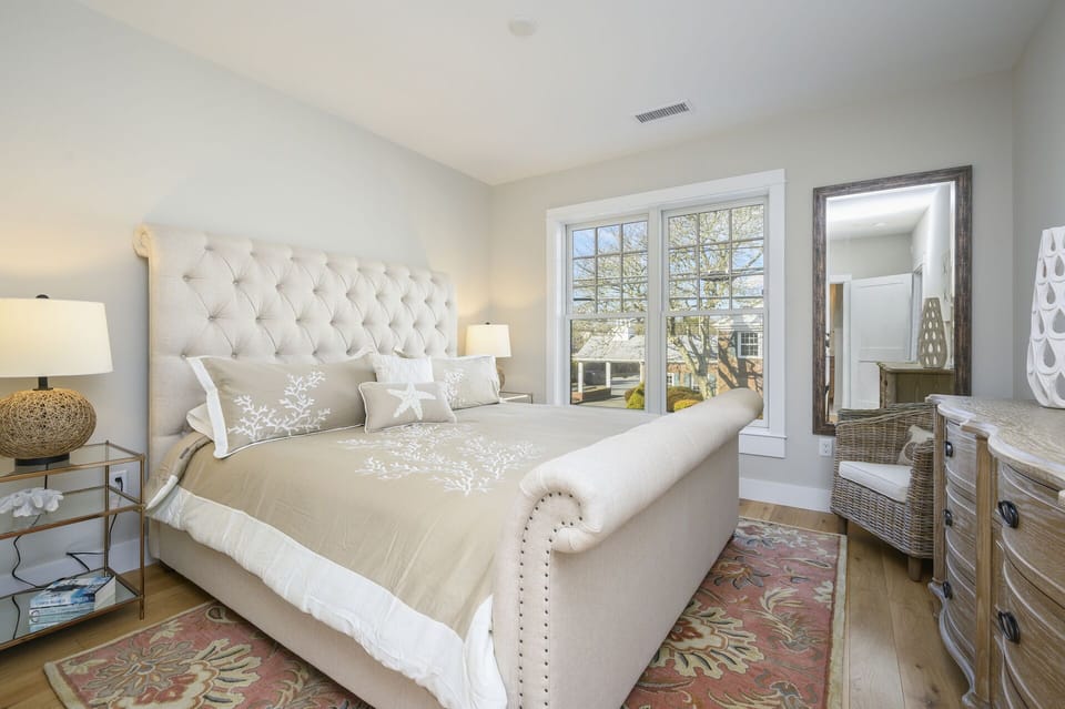 Plush, upholstered king size bed and large light-filled window