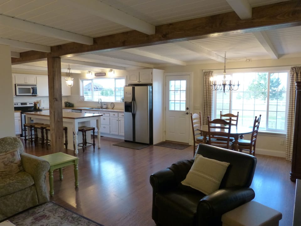 Living area is open and spacious. Big windows make it bright and cheery.