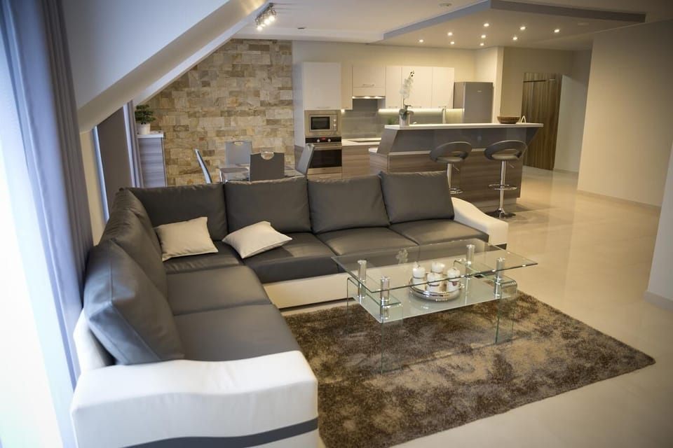 Suite, 2 Bedrooms | Living area | 50-inch Smart TV with cable channels, TV