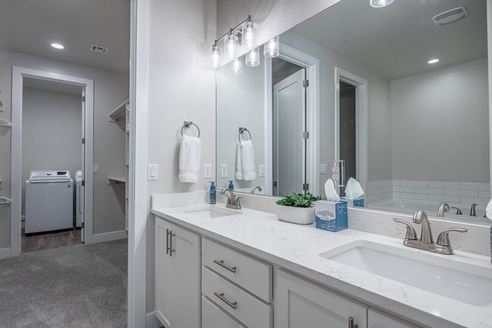 Main Bathroom - The Main bathroom that is adjacent to the Main bedroom is large and luxurious. With his and her sinks, toilet, vanity, walk-in shower, large bathtub and a large walk-in closet.