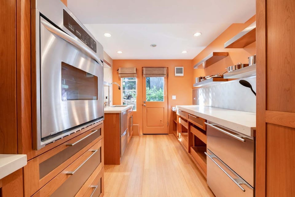 Bright and functional kitchen with modern appliances and elegant wood cabinets for a welcoming cooking space.