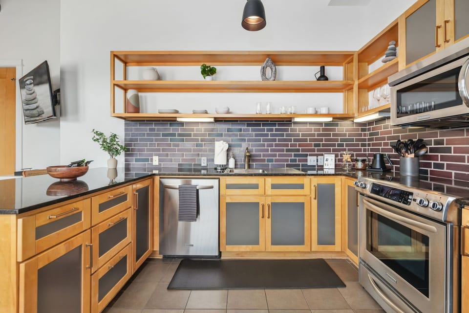 Sleek design with open shelving and stylish subway tile backsplash.
