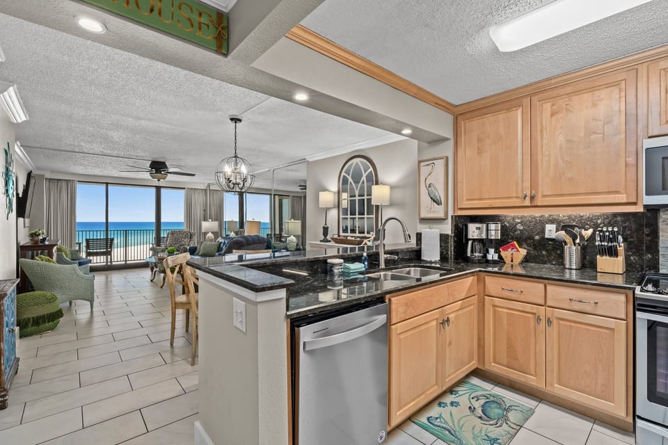 From the kitchen, the view stretches through the living room, past the private balcony, and straight to the sparkling Gulf coastline. This open layout keeps the breathtaking beach view front and center throughout the condo.