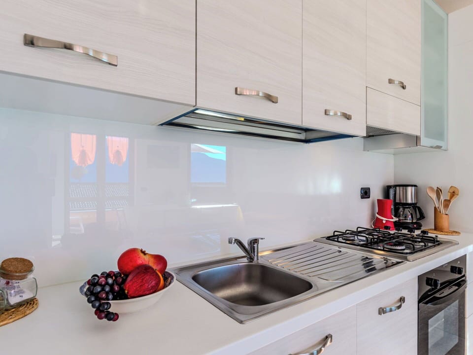 Kitchen, Countertop, Major Appliance, Kitchen Appliance, Interior Design, Kitchen Sink, Cabinetry, Home, Plumbing Fixture, Tap