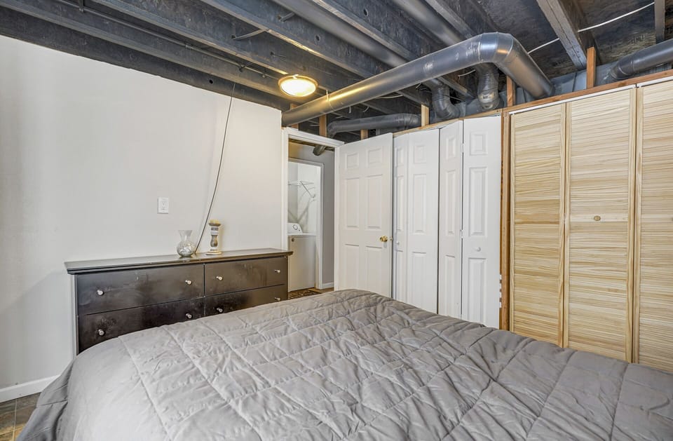 Basement bedroom has a queen sized bed