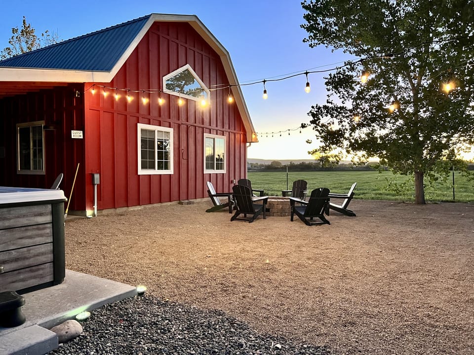 The red barn, fireplace and hot tub to the left. 