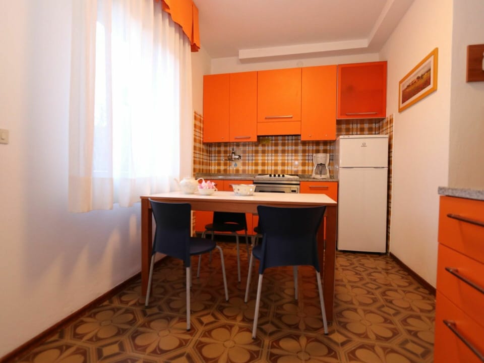 Cabinetry, Countertop, Furniture, Table, Building, Wood, Kitchen, Orange, Flooring, Interior Design