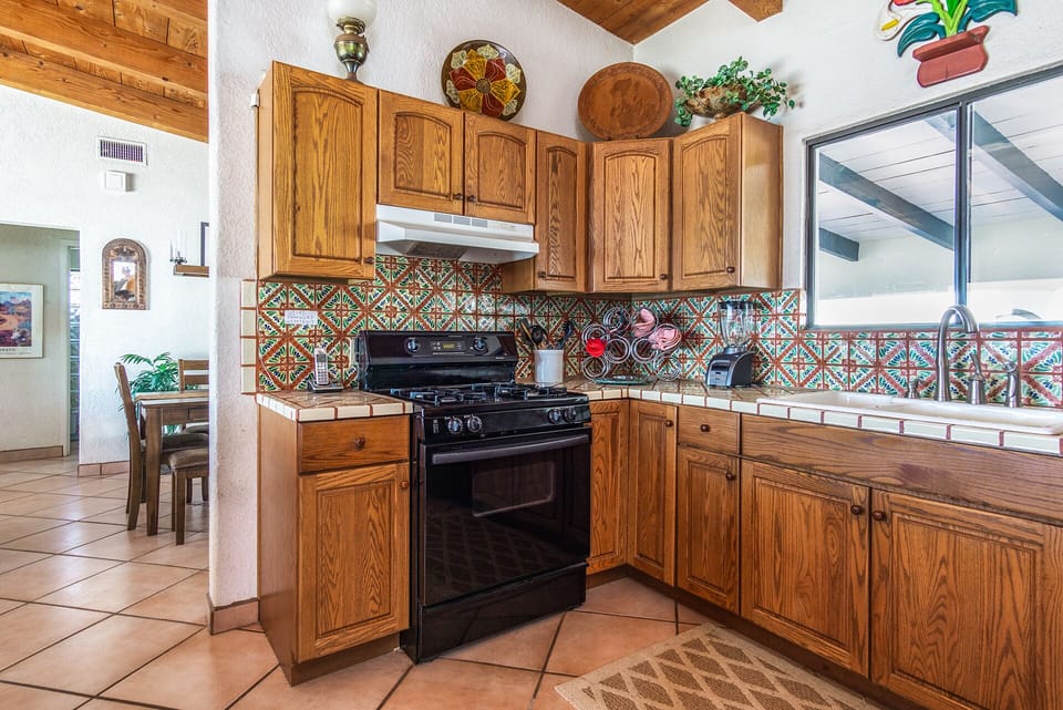 Fulled stocked kitchen with spice condiments, BBQ utensils and large supply of cookware
