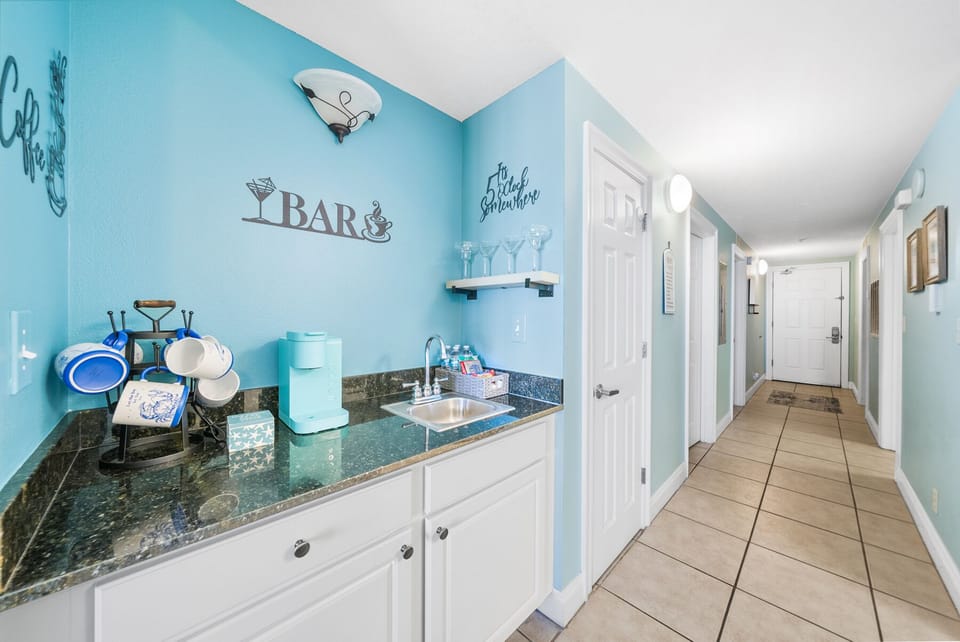 Your bright kitchenette features granite counters and beach-themed charm, perfect for quick snacks between ocean adventures.