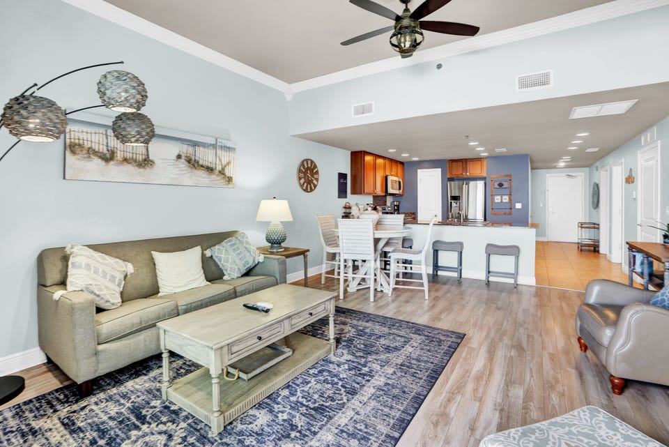 Relax in your bright open-concept space where coastal charm meets modern comfort, complete with ceiling fan and fully equipped kitchen.