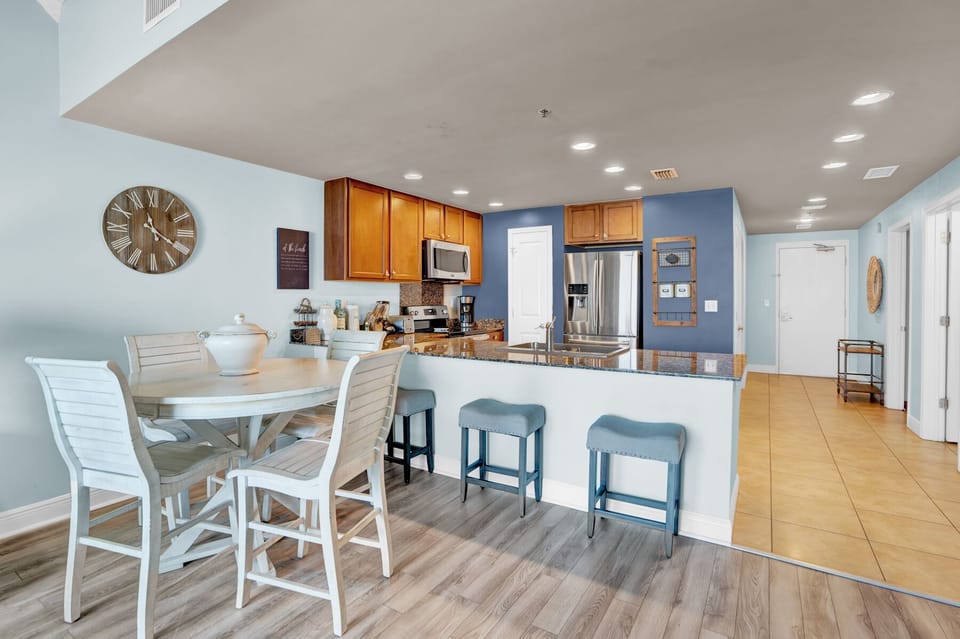 You'll love this open kitchen and dining space with granite counters, stainless appliances, and breakfast bar seating—perfect for your morning coffee.
