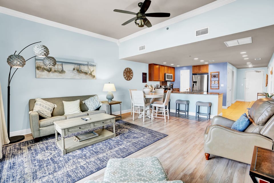 Unwind in your spacious living room where coastal blue tones and comfy seating create the perfect spot to relax after beach days.