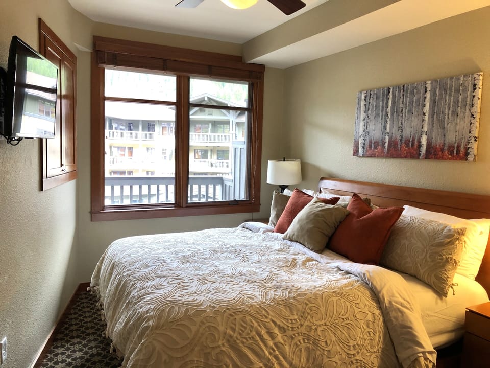 Bedroom with King Bed and mounted flat screen TV
