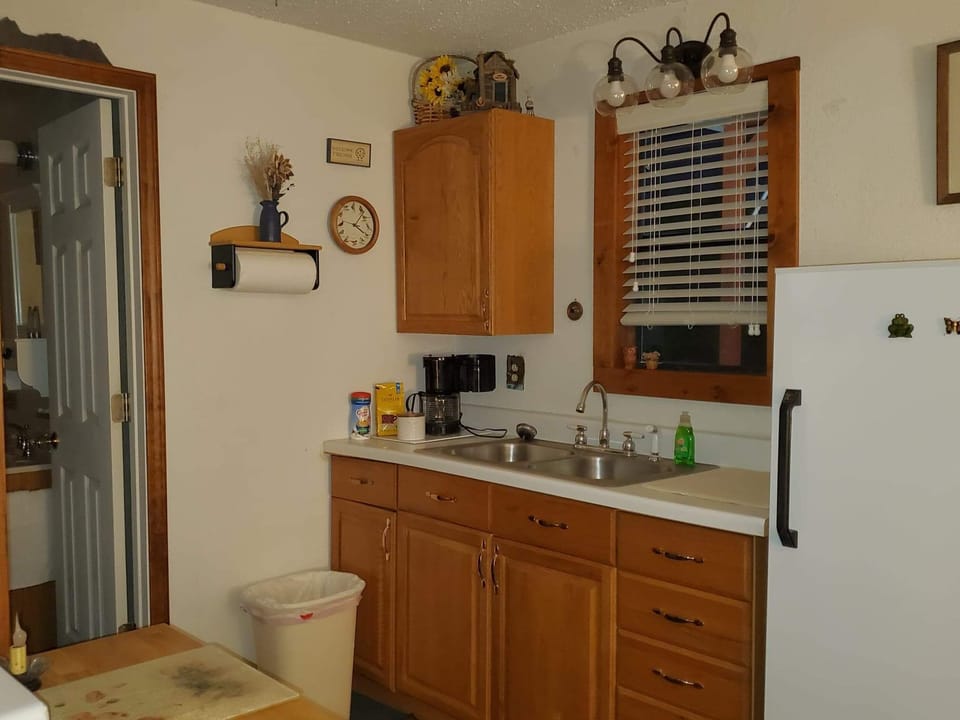 Kitchen with new microwave and small stovetop.