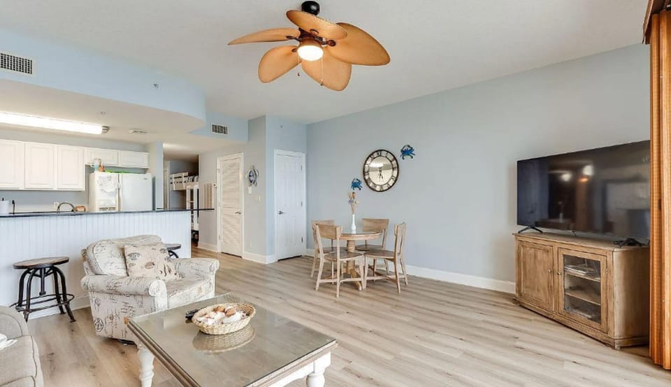 Relax in your open-plan coastal retreat where light wood floors and beach décor create a serene atmosphere for unwinding.