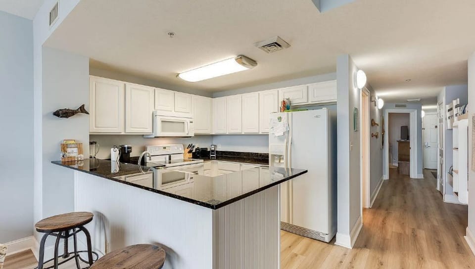 Your spacious kitchen awaits with gleaming granite countertops, stainless steel appliances, and a breakfast bar perfect for morning coffee.