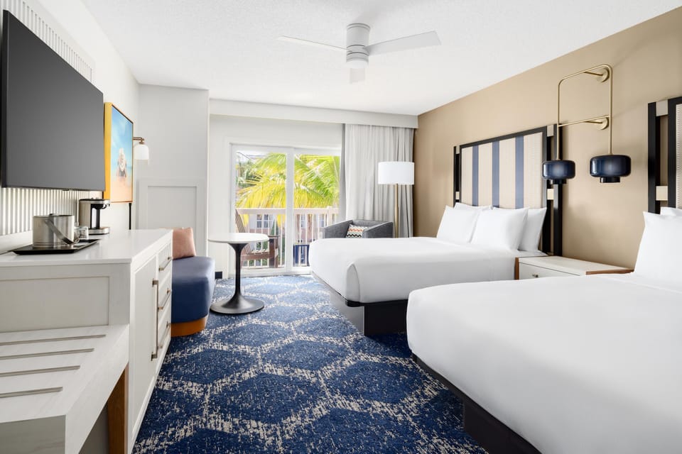 Room, 2 Queen Beds, Balcony, Pool View | Premium bedding, down comforters, in-room safe, desk