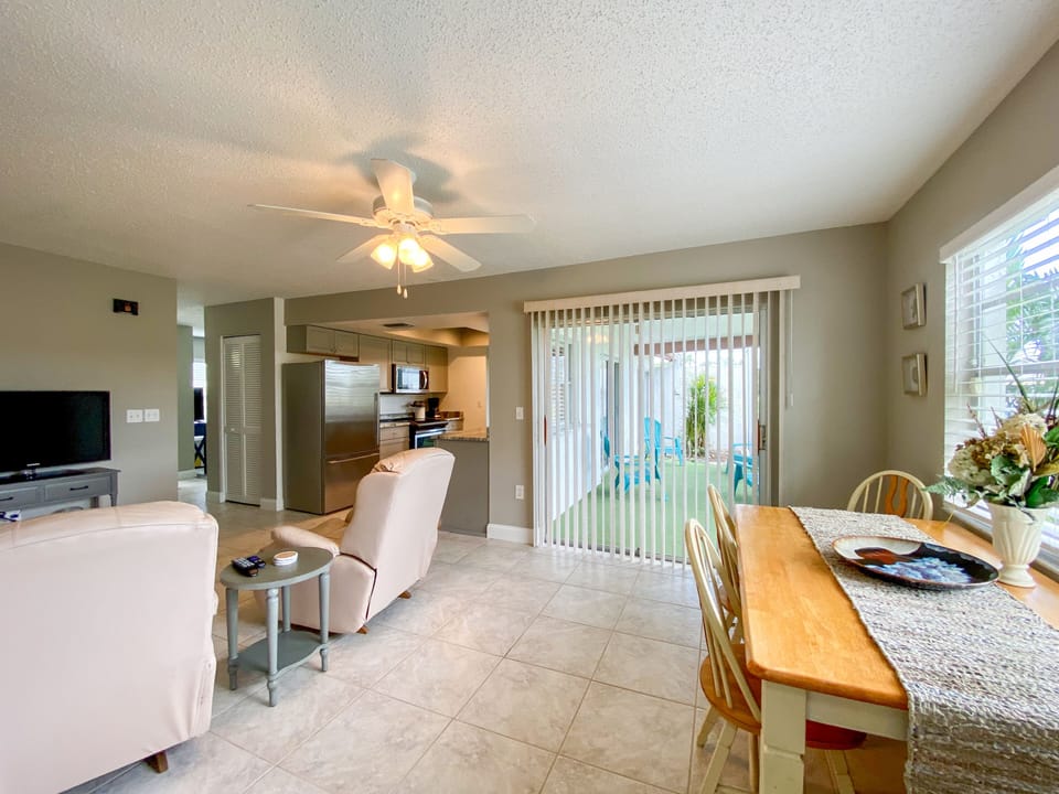 Family room off kitchen and slider leading to screened patio