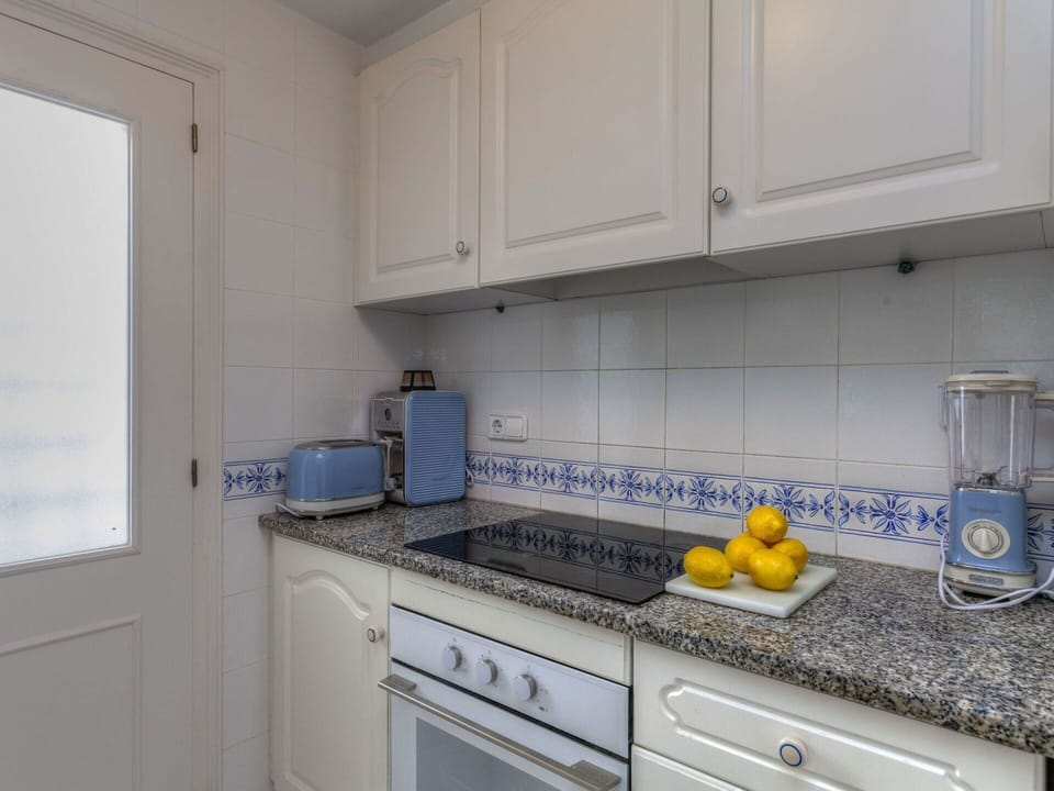 Countertop, Kitchen, Room, Property, Yellow, Tile, Cabinetry, Furniture, Real Estate, Floor