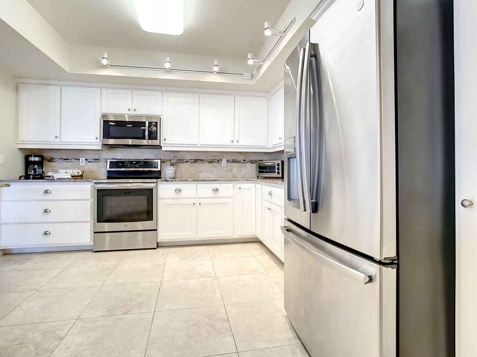 Kitchen with refrigerator, dishwasher, and coffee maker