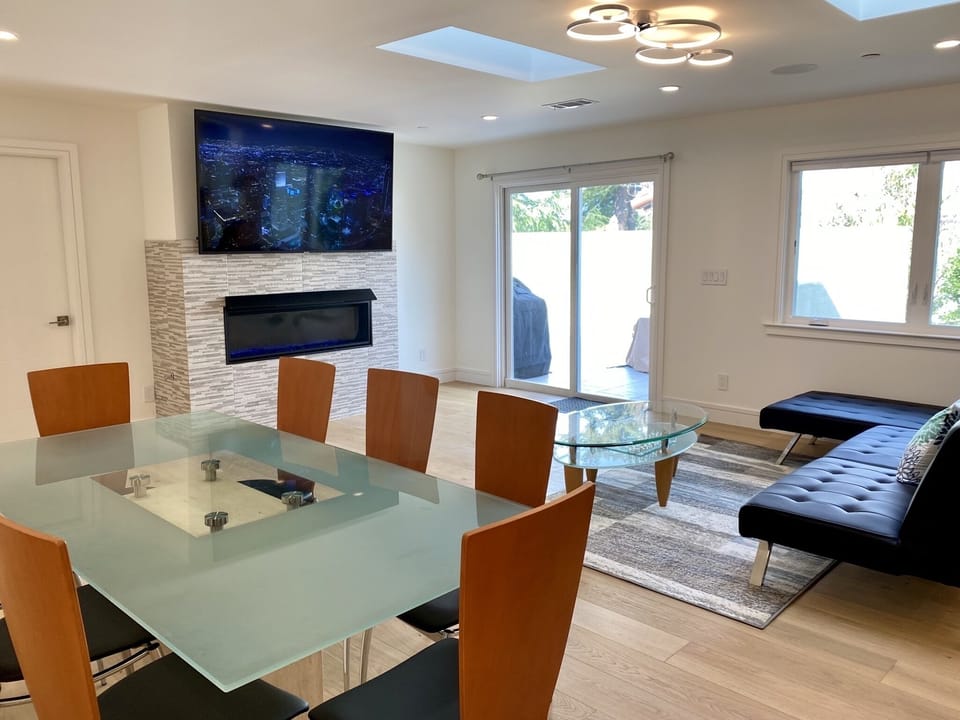 glass dining table, 8 genuine leather chairs, 75-inch TV, sofa bed, sun deck
