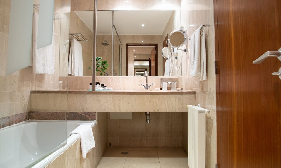 Bathtub, deep soaking tub, eco-friendly toiletries, hair dryer