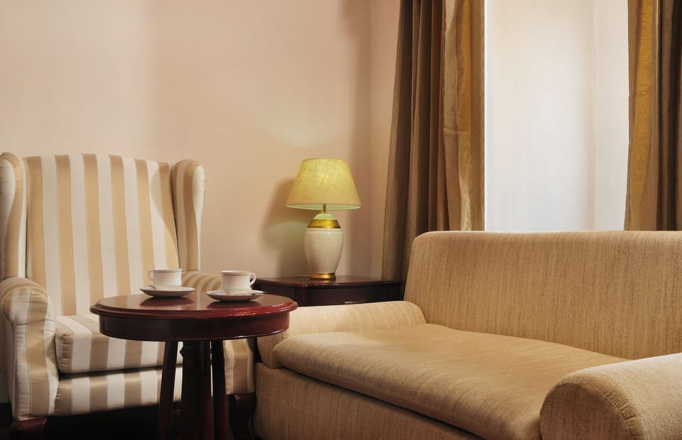 Premium Room, 1 King Bed | Living area | 36-inch LCD TV with cable channels, TV