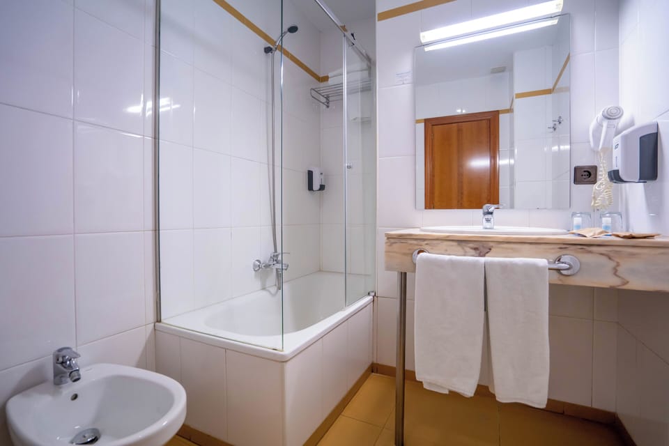 Bathtub, eco-friendly toiletries, hair dryer, bidet