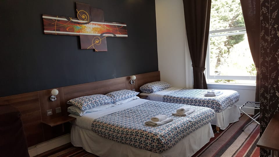 Family Quad Room for 2 adults and 2 children | Pillowtop beds, desk, free WiFi, bed sheets