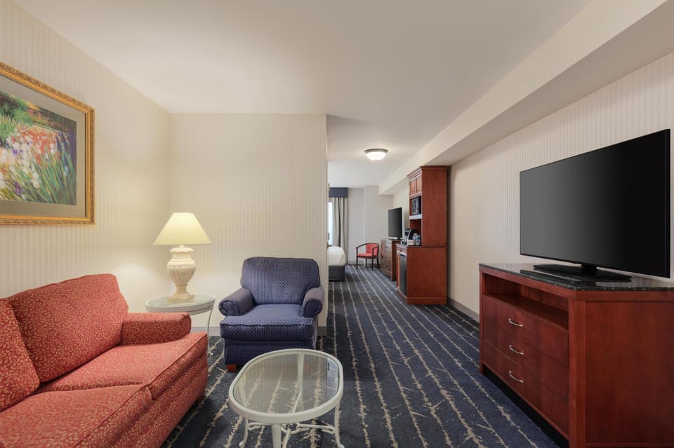King Junior Suite | Living area | 32-inch flat-screen TV with cable channels, TV, pay movies
