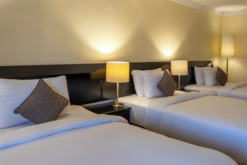 Basic Triple Room | Minibar, in-room safe, desk, blackout drapes