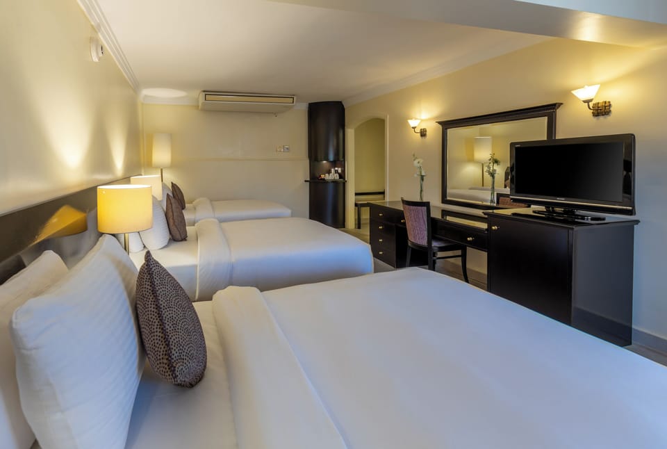 Basic Triple Room | Minibar, in-room safe, desk, blackout drapes