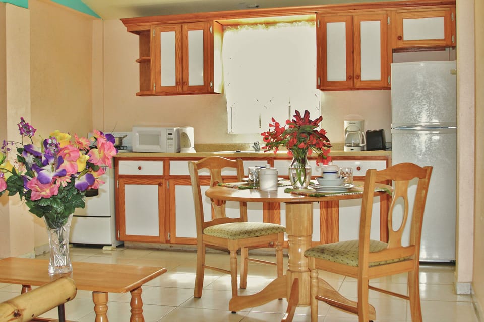 Full-size fridge, microwave, stovetop, cookware/dishes/utensils