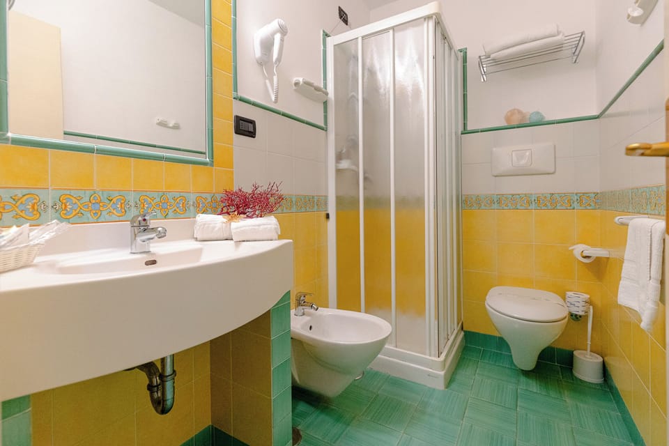 Family Triple Room, Garden View | Bathroom | Shower, free toiletries, hair dryer, bathrobes