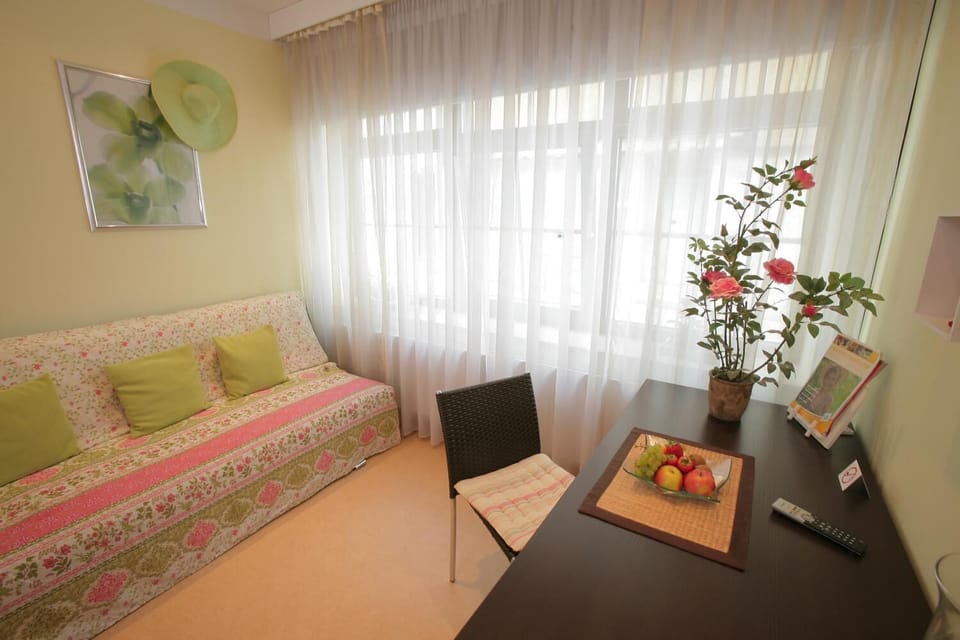 Standard Triple Room | Living room | Flat-screen TV