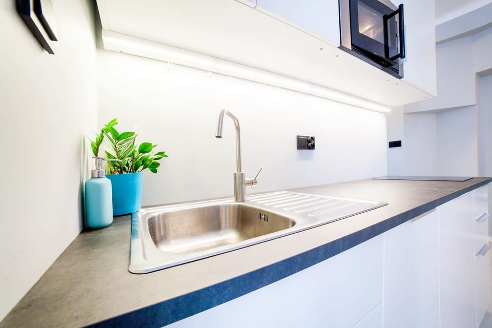Fully equipped kitchenette with kettle, fridge freezer, dishwasher, induction hob, microwave and toaster.