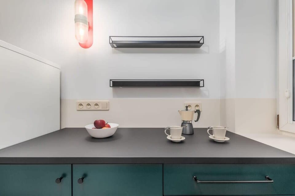 Kitchen with a kettle, fridge freezer, dishwasher, gas hob and oven.
