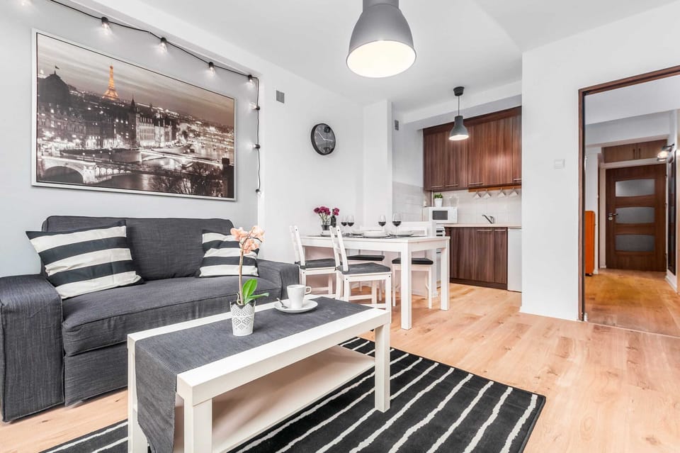 Living room with a sofa bed and fully equipped kitchenette.