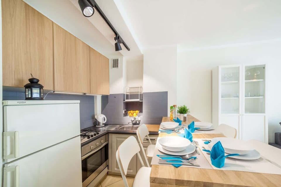 The living area features a sleek coffee table and a flat-screen television.